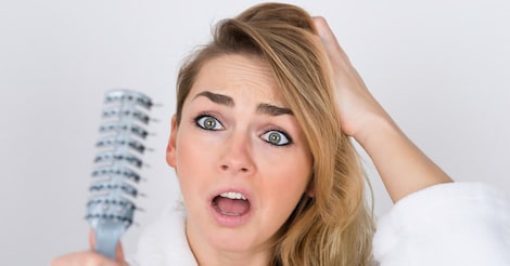 Worried Woman Looking At Comb