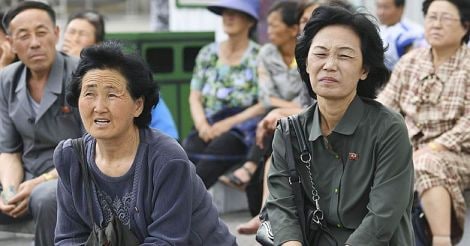 North Koreans watch  Kim's Singapore visit