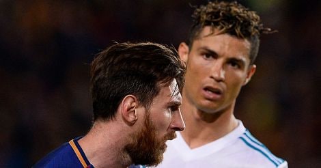 Cristiano Ronaldo (R) looks at Lionel Messi 
