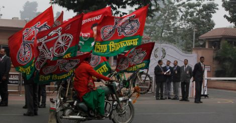  A Samajwadi Party supporter riding a bike with party flags