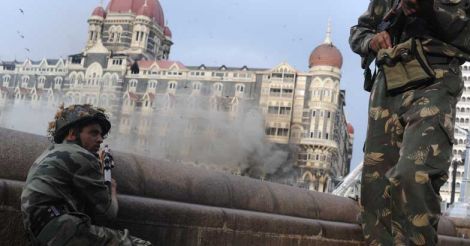 An Indian soldier aims his weapon towards The Taj Mahal Hotel in Mumbai on November 29, 2008, during a military operation.