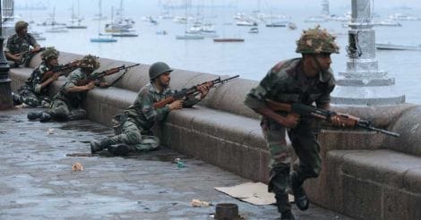 In this file photo taken on November 29, 2008 Indian soldiers take cover during a military operation at the Taj Mahal Palace hotel in Mumbai.