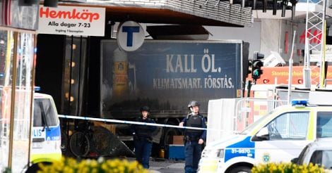Police cordon off the truck which crashed into the Ahlens department store at Drottninggatan in central Stockholm.