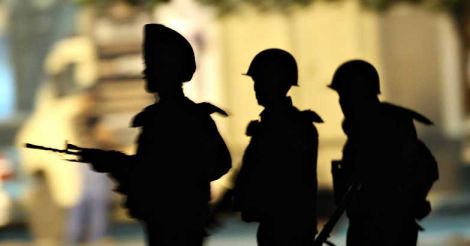 Indian Army soldiers take their positions outside the Taj Mahal Hotel in Mumbai on November 28, 2008