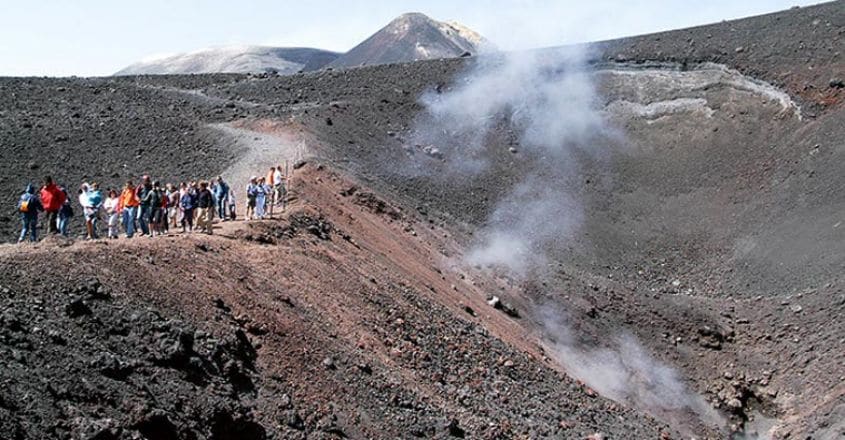 People hiking at mount Etna on the island of Sicily