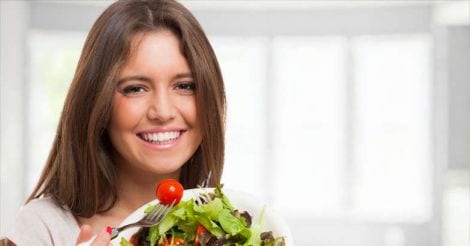 Young woman eating a healthy salad