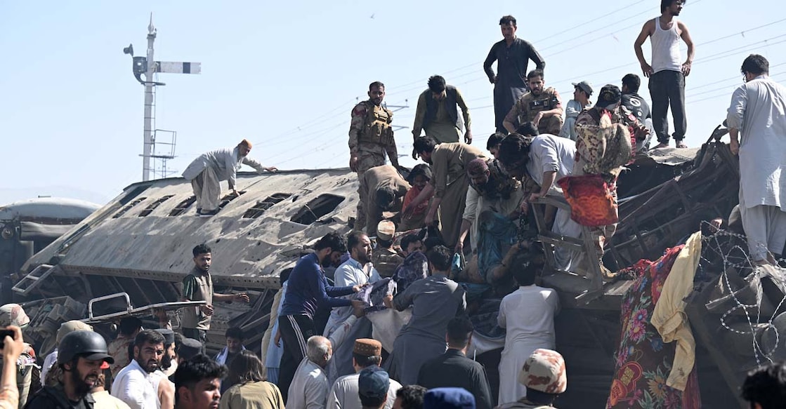 Rescue workers at the site of a blast on a track in Balochistan, Pakistan. (Photo by Banaras Khan/AFP)