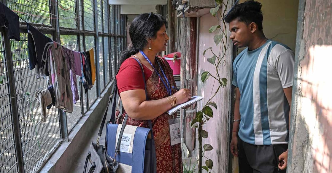Enumerator visiting houses in New Delhi as part of the first phase census. (Photo by Arun Sankar/AFP)