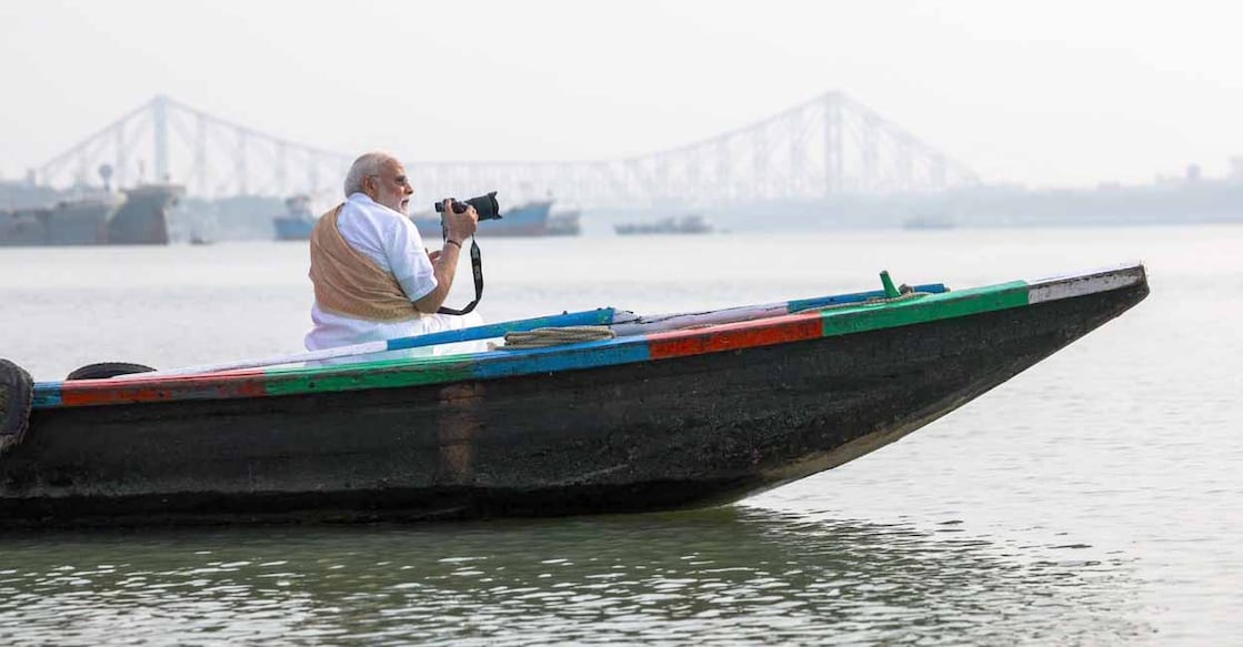 **EDS: THIRD PARTY IMAGE** In this image released on April 24, 2026, Prime Minister Narendra Modi tries his hand at photography during a boat ride on the Hooghly River ahead of the second phase of the West Bengal Assembly elections, in Kolkata. (@narendramodi/X via PTI Photo)(PTI04_24_2026_000015B)