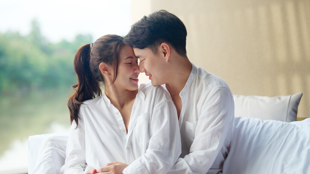 Young adult asia people fiance happy lover flirt fall in love nose lips kiss hug cuddle care trust. Sweet comfort touch newlywed asian couple life man smile look at woman face relax warm time dating.