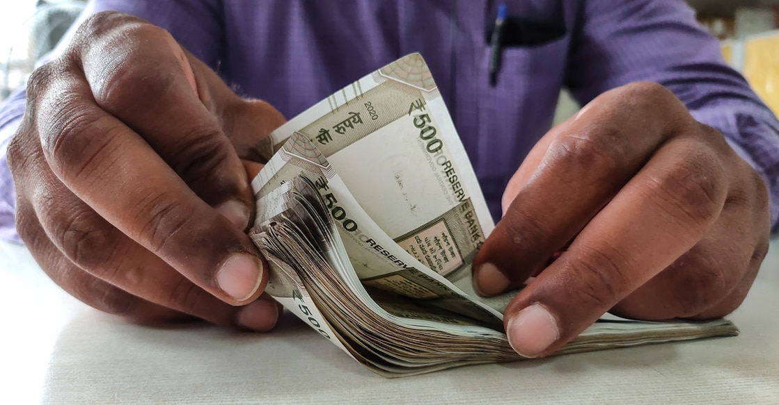 Kolkata, India dated 15/08/2020. Man counting indian currency with hands.
