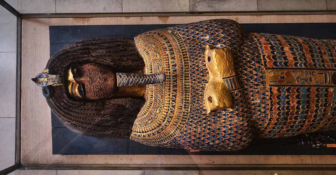 Close shot of a gold Akhenaten's coffin lid from the 18th dynasty at the Egyptian Museum.  Photo Credits:  BERK OZDEMIR/ Shutterstock.com
