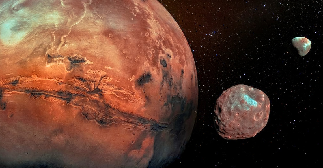 Mars with its two cratered moons Phobos and Deimos. Elements of this image furnished by NASA..  Photo credits: Elen11/ istock.com
