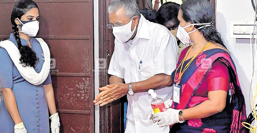 പിണറായി ആർസി അമല ബേസിക് യുപി സ്കൂളിലെ ബൂത്തിൽ വോട്ട് ചെയ്യാനെത്തിയ മുഖ്യമന്ത്രി പിണറായി വിജയൻ സാനിറ്റൈസർ ഉപയോഗിച്ച ശേഷം ബൂത്തിലേക്കു പ്രവേശിക്കുന്നു. ചിത്രം: മനോരമ പിണറായി ആർസി അമല ബേസിക് യുപി സ്കൂളിലെ ബൂത്തിൽ വോട്ട് ചെയ്യാനെത്തിയ മുഖ്യമന്ത്രി പിണറായി വിജയൻ സാനിറ്റൈസർ ഉപയോഗിച്ച ശേഷം ബൂത്തിലേക്കു പ്രവേശിക്കുന്നു. ചിത്രം: മനോരമ