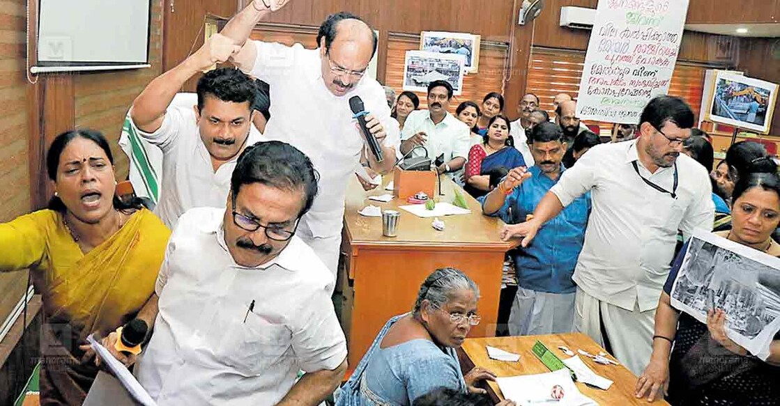 മേൽക്കൂര വീണതിലും നഗരത്തിലെ പഴക്കം ചെന്ന കെട്ടിടങ്ങൾ പൊളിച്ച് നീക്കാത്തതിലും കോൺഗ്രസ്, ബിജെപി കൗൺസിലർമാർ നടത്തിയ പ്രതിഷേധത്തെ തുടർന്ന് മേയർ ചെയറിൽ നിന്ന് ഇറങ്ങി പോകുന്നു.