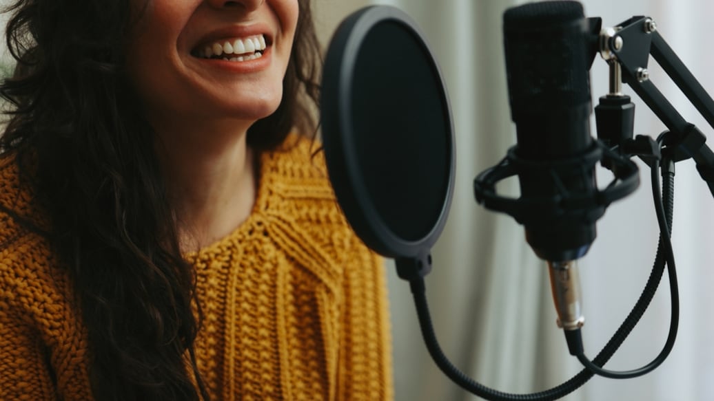 2199797375 Young woman dubbing voiceover for broadcast stream live show