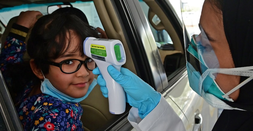 A nurse measures the body temperature coronavirus COVID-19 uae A nurse measures the body temperature coronavirus COVID-19 uae