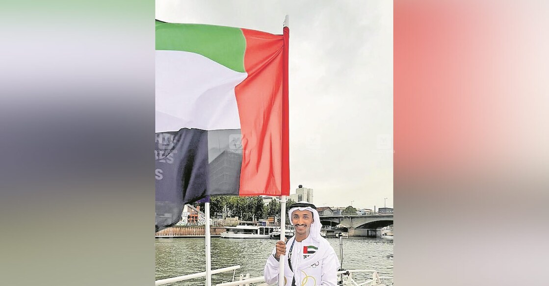 omar-al-marzouqi-safiya-al-sayegh-carrying-uae-flag-during-paris-olympics-2024 omar-al-marzouqi-safiya-al-sayegh-carrying-uae-flag-during-paris-olympics-2024