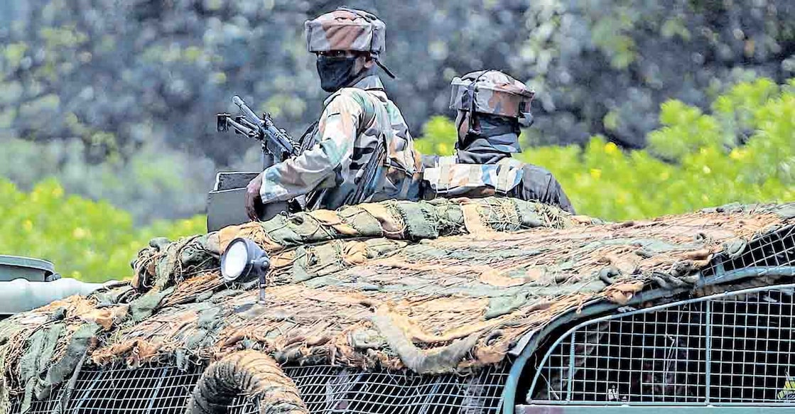 Indian army soldiers patrol on the Jammu-Pathankot highway after troops around midnight spotted two drones separately flying over Kaluchak military base on the outskirts of Jammu, India, Monday, June 28, 2021. India's military said it thwarted a major threat when it intercepted two drones flying over an army base in Indian-controlled Kashmir early Monday, a day after suspected explosives-laden drones were used to attack an air base in the disputed region. (AP Photo/Channi Anand)