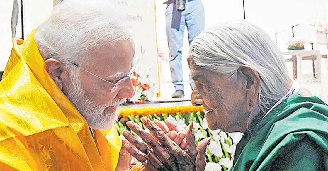 **EDS: IMAGE VIA PIB** New Delhi: Prime Minister Narendra Modi being presented a shawl by an elderly farmer during the 'Global Millets (Shree Anna) Conference' in Pusa, in New Delhi, Saturday, March 18, 2023. (PTI Photo)    (PTI03_18_2023_000135B)