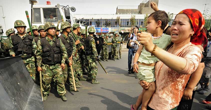 uyghur-woman-protest uyghur-woman-protest