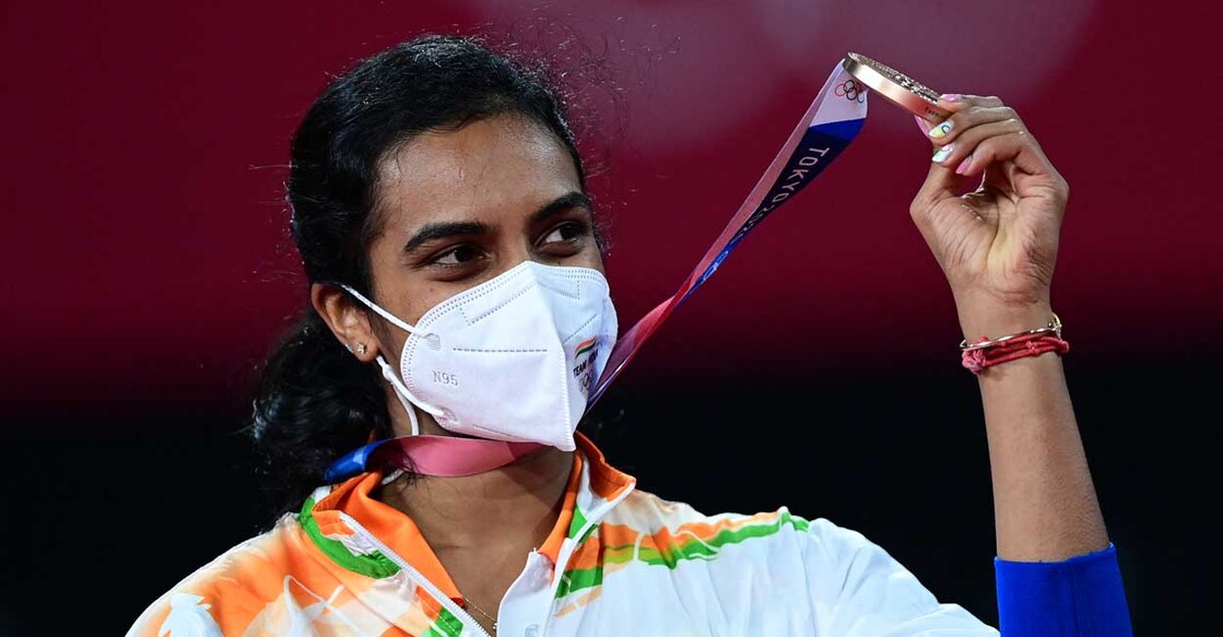 India's P. V. Sindhu poses with her women's singles badminton bronze medal at a ceremony during the Tokyo 2020 Olympic Games at the Musashino Forest Sports Plaza in Tokyo on August 1, 2021. (Photo by Pedro PARDO / AFP)