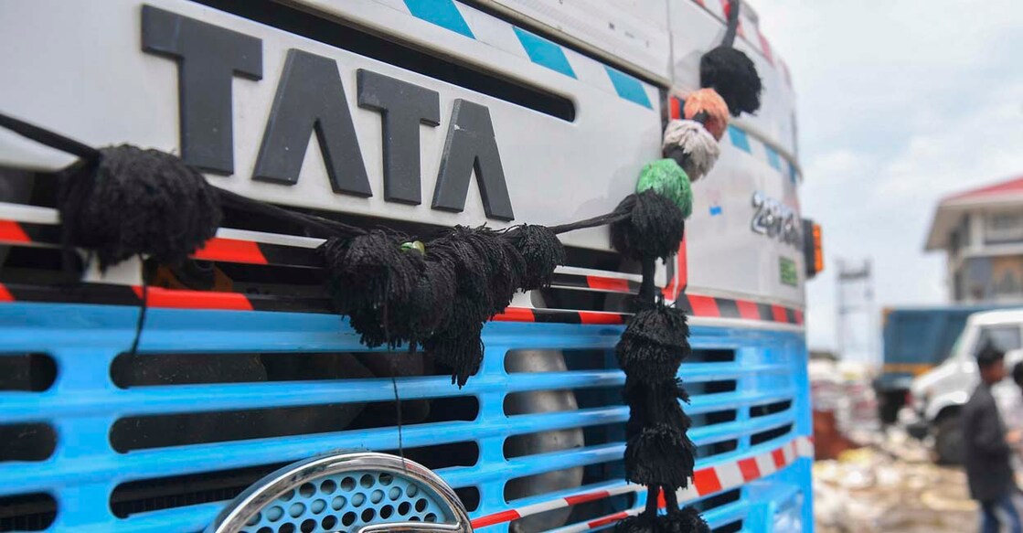 The Tata Motors logo and signage is seen on the engine grille of a truck, at a parking lot in Mumbai on June 15, 2020. (Photo by INDRANIL MUKHERJEE / AFP)