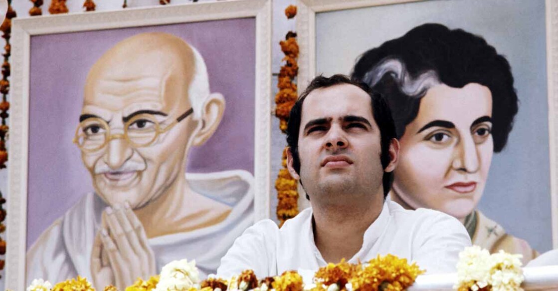 Unlocated picture of Sanjay Gandhi taken during a meeting in Avril 1976 in front of portrait of Mahatma Gandhi and of his mother Indira Gandhi. (Photo by AFP)