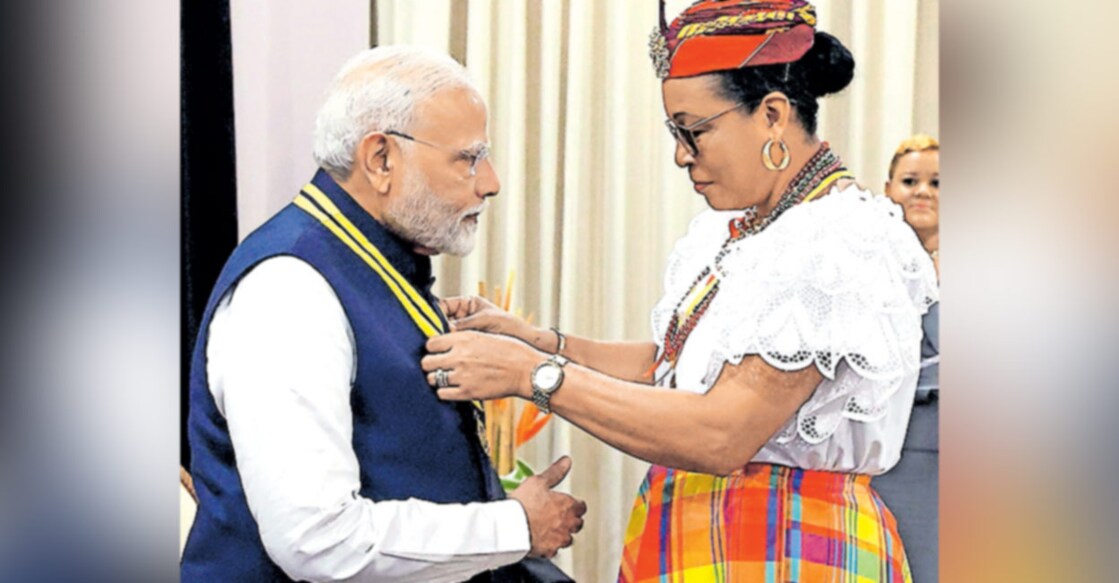 narendra-modi-sylvanieburton കരീബിയൻ ദ്വീപു രാഷ്ട്രമായ ഡൊമീനിക്കയുടെ പരമോന്നത ബഹുമതിയായ ‘ഡൊമീനിക്ക അവാർഡ് ഓഫ് ഓണർ’ ഇന്ത്യൻ പ്രധാനമന്ത്രി നരേന്ദ്ര മോദിക്കു ഡൊമീനിക്ക പ്രസിഡന്റ് സിൽവാനി ബർട്ടൻ സമ്മാനിക്കുന്നു. ചിത്രം: പിടിഐ