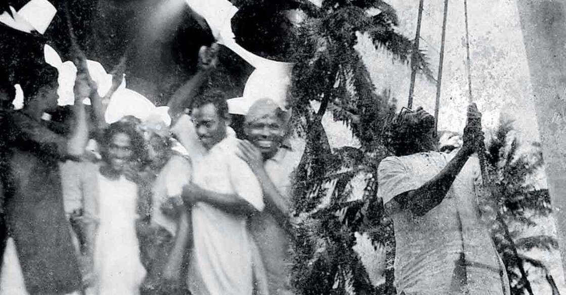 Celebration after liberation of Mayyazhi (1) മയ്യഴി സ്വതന്ത്രമായി എന്നറിഞ്ഞ സ്വാതന്ത്ര്യപ്പോരാളികളുടെ ആഘോഷം (2) രണ്ടു പതിറ്റാണ്ട് ഫ്രഞ്ച് പതാക പാറിയ കൂറ്റൻ കൊടിമരത്തിൽ ഐ.കെ.കുമാരൻ ഇന്ത്യൻ പതാക ഉയർത്തുന്നു.