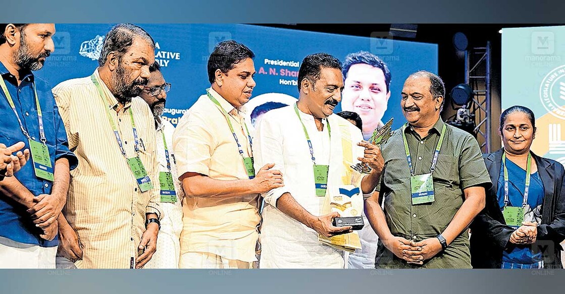 prakash-raj-kerala-assembly-book-festival കേരള നിയമസഭയിൽ രാജ്യാന്തര പുസ്തകോത്സവത്തിന്റെ സമാപന സമ്മേളന വേദിയിൽ ഉപഹാരമായി കിട്ടിയ ആറന്മുള കണ്ണാടി നടൻ പ്രകാശ് രാജ് കൗതുകത്തോടെ നോക്കുന്നു. പി.സി.വിഷ്ണുനാഥ് എംഎൽഎ, മന്ത്രി വി.ശിവൻകുട്ടി, ഡപ്യൂട്ടി സ്പീക്കർ ചിറ്റയം ഗോപകുമാർ, സ്പീക്കർ എ.എൻ. ഷംസീർ, മന്ത്രി കെ.എൻ.ബാലഗോപാൽ, ശ്രീലങ്കൻ സാഹിത്യകാരി വി.വി.പത്മസീലി എന്നിവർ സമീപം. ചിത്രം: മനോരമ