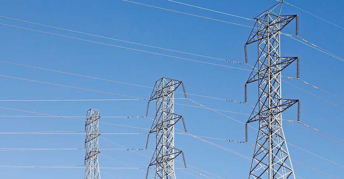 Beautiful shot of electric poles under a blue sky beautiful shot of electric poles under a blue sky
