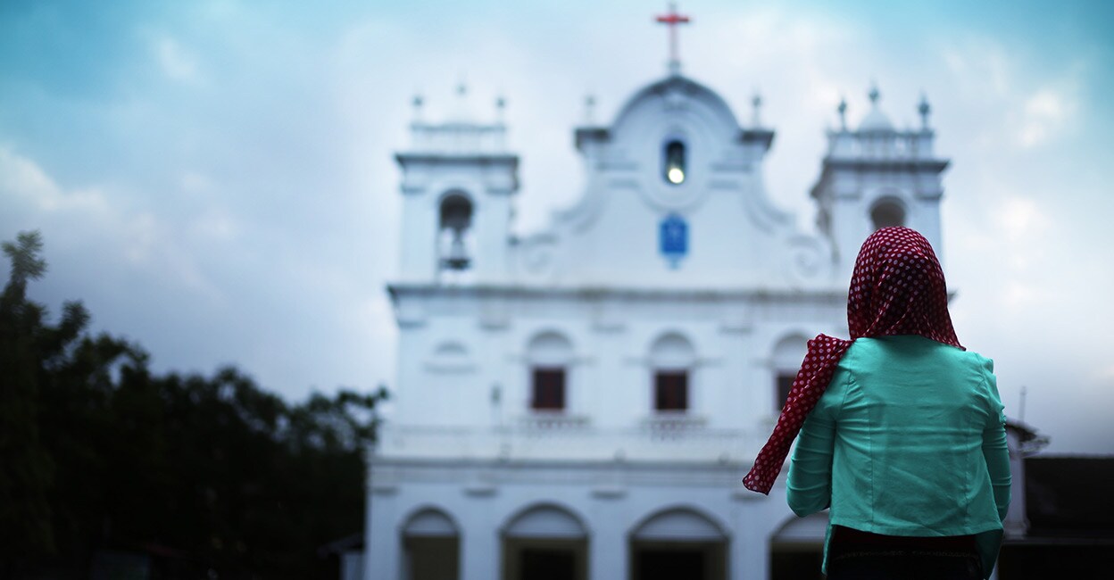 woman-standing-in-front-of-holy-church woman-standing-in-front-of-holy-church