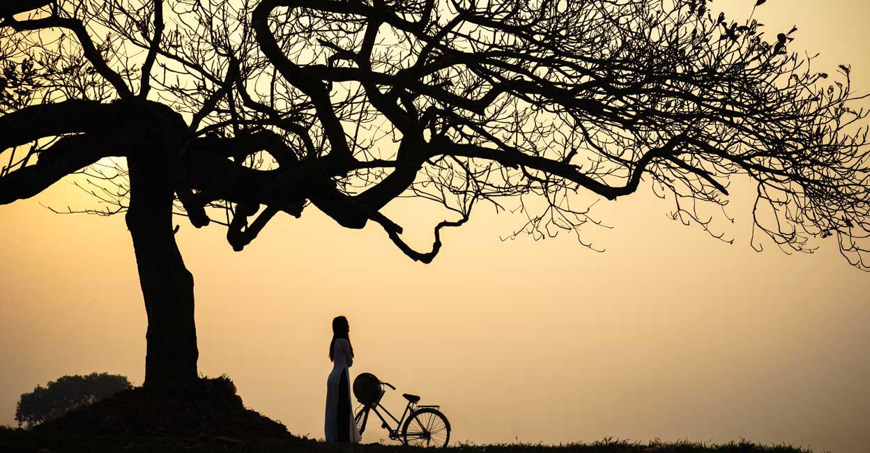 Beautiful landscape woman standing under the tree Representative Image: Photo by: Vietnam Stock Images/Shutterstock.