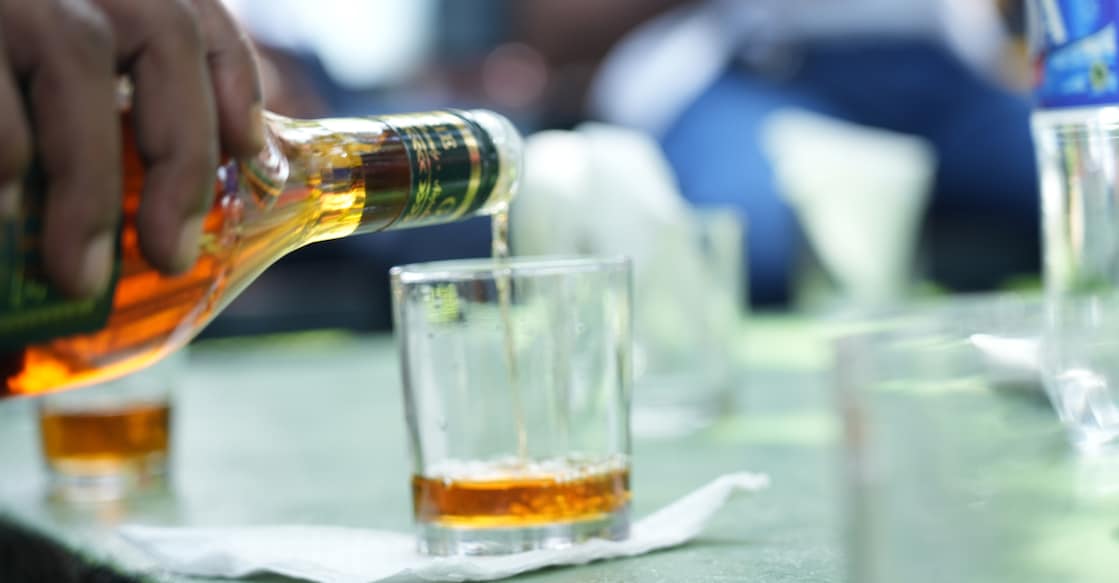 2166730003 pouring alcohol to a glass