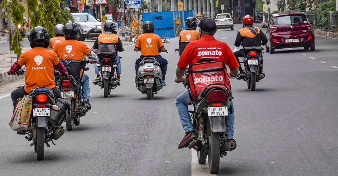New Delhi: Deliverymen of food aggregators Swiggy and Zomato ride on their bikes towards their destinations during the nationwide lockdown, imposed in the wake of coronavirus pandemic, at Vikas Marg in East Delhi, Tuesday, March 31, 2020. (PTI Photo)(PTI31-03-2020_000245B)