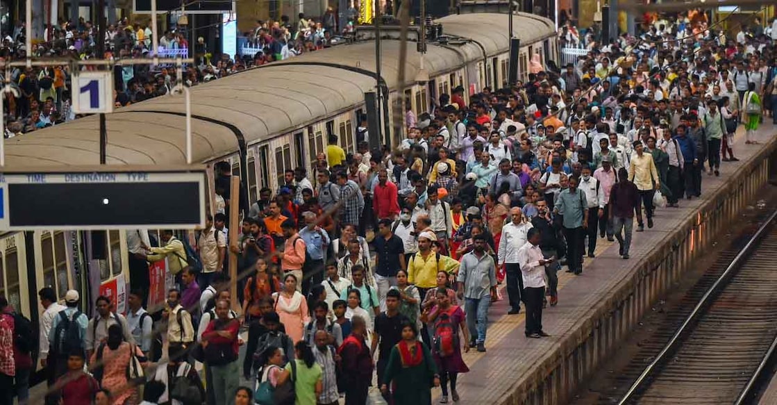 People crowd on platforms as they wait for their train at the Chhatrapati Shivaji Terminus (CST) railway station Mumbai on April 19, 2023. India is set to overtake China as the world's most populous country by the end of June, UN estimates showed on April 19, 2023, posing huge challenges to a nation with creaking infrastructure and insufficient jobs for millions of young people. (Photo by Punit PARANJPE / AFP)