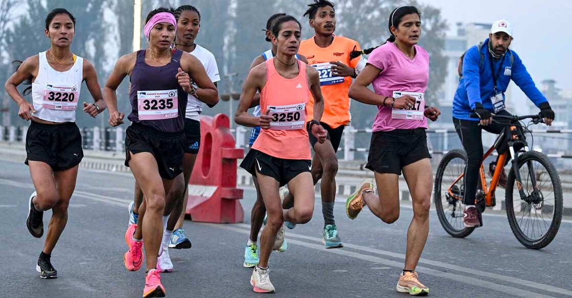 Participants run during the Kashmir Marathon event in Srinagar on October 20, 2024. (Photo by TAUSEEF MUSTAFA / AFP)