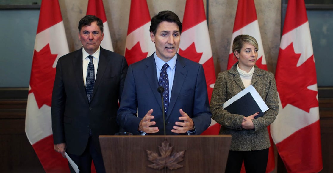 Canadian Prime Minister Justin Trudeau (C), with Foreign Minister Mélanie Joly (R) and Public Safety Minister Dominic LeBlanc speaks during a press conference on October 14, 2024, on Parliament Hill in Ottawa, after Canada expelled six top Indian diplomats, including the country's ambassador. - India and Canada each expelled the other's ambassador and five other top diplomats, after New Delhi said its envoy had been named among "persons of interest" following the 2023 murder of Canadian citizen Hardeep Singh Nijjar, a Sikh separatist leader. (Photo by Dave Chan / AFP)