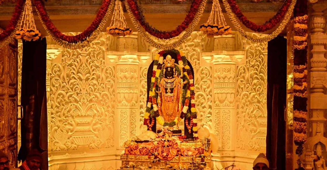 Priets sit near the idol of Hindu deity Ram at the newly consecrated temple in Ayodhya in India's Uttar Pradesh state on January 22, 2024. - Prime Minister Narendra Modi said the opening of a temple on January 22, heralded a "new era" for India, at a ceremony that embodies the triumph of his muscular Hindu nationalist politics, galvanising loyalists ahead of elections this year. (Photo by Money SHARMA / AFP)