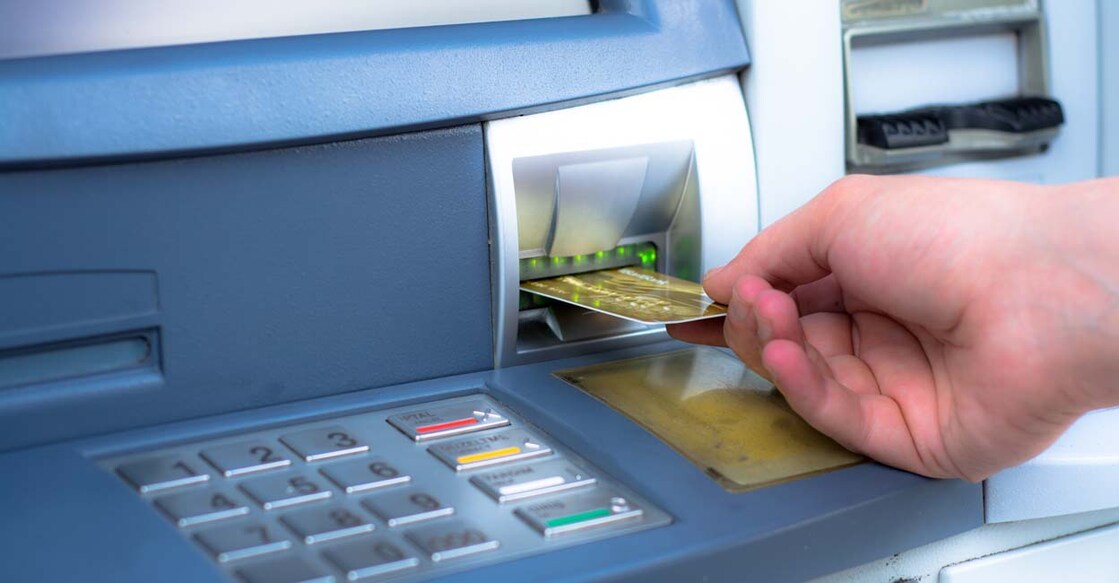 Hand inserting ATM credit card