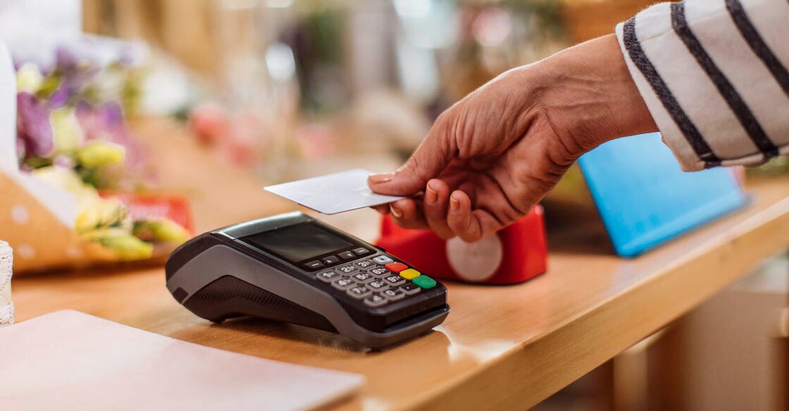 Unrecognizable person making a contactless credit card payment at the flower shop