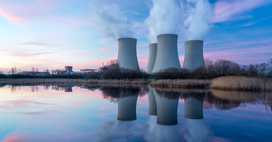 658599072 Nuclear power plant after sunset. Dusk landscape with big chimneys.