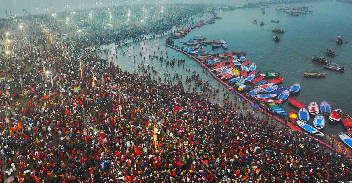 This aerial handout photograph taken and released by India's Uttar Pradesh State Information Department on January 13, 2025 shows Hindu pilgrims taking a holy dip in the sacred waters of Sangam, the confluence of Ganges, Yamuna and mythical Saraswati rivers, during the Maha Kumbh Mela festival in Prayagraj. Vast crowds of Hindu pilgrims in India bathed in sacred waters as the Kumbh Mela festival opened on January 13, with organisers expecting 400 million people -- the world's largest gathering of humanity -- to assemble over six weeks. (Photo by India's Uttar Pradesh State Information Department / AFP) / RESTRICTED TO EDITORIAL USE - MANDATORY CREDIT "AFP PHOTO / INDIA'S UTTAR PRADESH STATE INFORMATION DEPARTMENT " - NO MARKETING NO ADVERTISING CAMPAIGNS - DISTRIBUTED AS A SERVICE TO CLIENTS