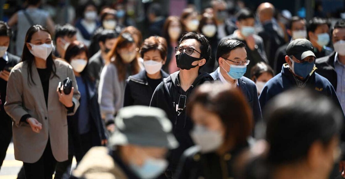 People wear masks on a street People wear masks on a street