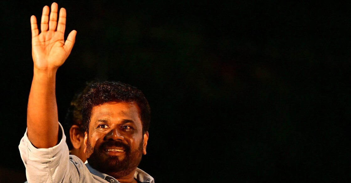 SRI LANKA-POLITICS-VOTE National People's Power (NPP) presidential candidate Anura Kumara Dissanayaka, waves to his supporters during a rally ahead of the upcoming presidential elections in Colombo on September 18, 2024. - Sri Lanka's presidential hopeful Anura Kumara Dissanayaka wants a peaceful revolution after his Marxist party failed to seize power in two uprisings that left more than 80,000 people dead. The cash-strapped nation will vote for its next president on September 21. (Photo by Ishara S. KODIKARA / AFP)