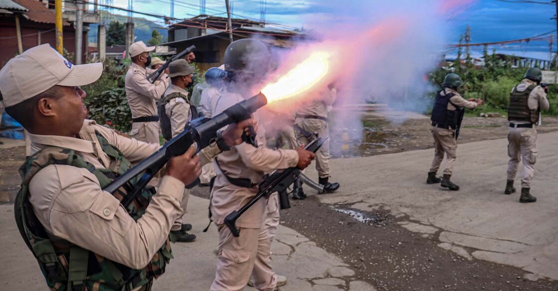 A policeman fires tear gas to the protesters as they demand restoration of peace in India's northeastern state of Manipur after ethnic violence, in Imphal on September 21, 2023. (Photo by AFP)