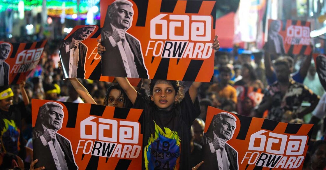 Supporters of Sri Lanka's president and independent presidential candidate Ranil Wickremesinghe attend an election rally ahead of the upcoming presidential elections in Colombo on September 18, 2024. - Sri Lanka's right-wing President Ranil Wickremesinghe, who seeks re-election this week, describes himself as the "designated survivor" capable of salvaging the economically troubled nation. Critics, however, say the 75-year-old six-time prime minister has been the beneficiary of circumstances, rising the ranks via power vacuums left by assassinations and resignations. (Photo by AFP)