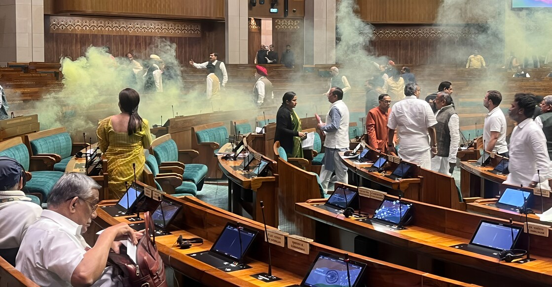 parliament-attack-1 A visitor jumps in the Lok Sabha chamber from the public gallery. photo shared by DMK MP Dr S Senthilkumar on X 13/12/ 2023