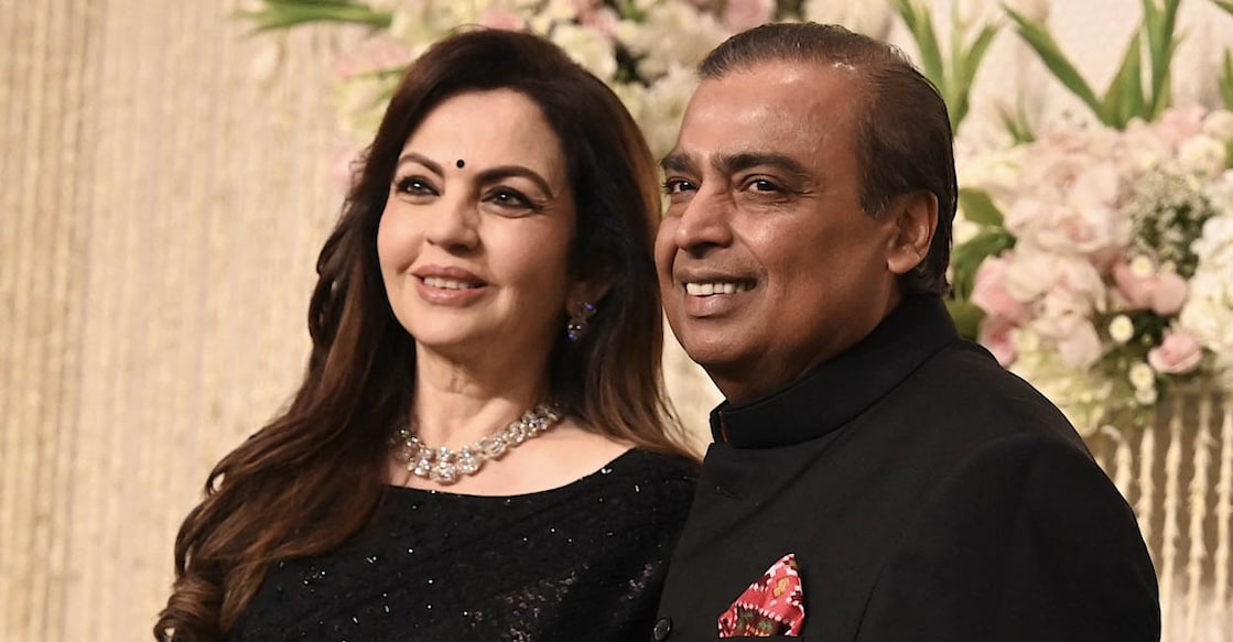 INDIA-ENTERTAINMENT-CINEMA-BOLLYWOOD Chairman and Managing Director of Reliance Industries, Indian billionaire businessman Mukesh Ambani with his wife and Founder Chairperson of the Reliance Foundation Nita Ambani poses for a photograph during the wedding reception ceremony of actor Amir Khan's daughter, Ira Khan, in Mumbai on January 13, 2024. (Photo by SUJIT JAISWAL / AFP)